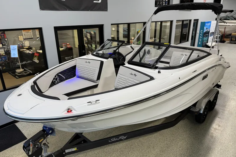 Slide: The Image of 2026 Sea Ray SPX 210 boat displayed indoors on a trailer. - 5