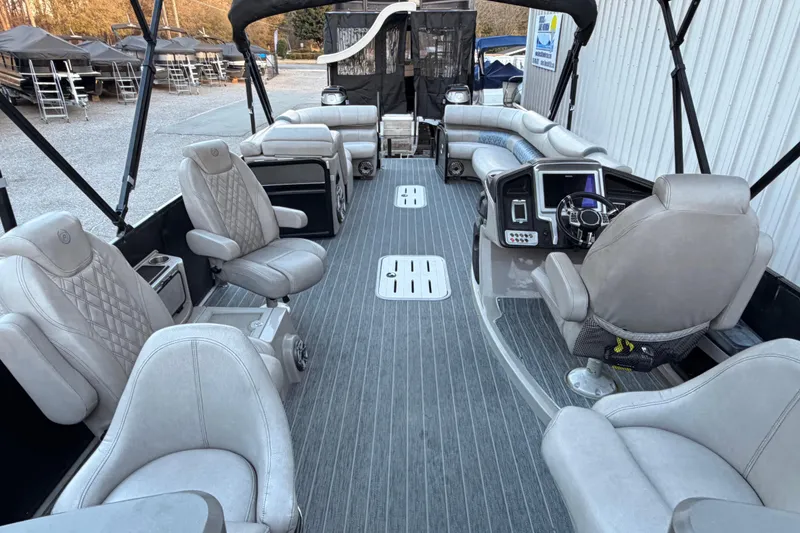 Slide: The Image of Luxurious interior of 2021 Premier 310 Accolade pontoon boat with plush seating and modern dashboard. - 10