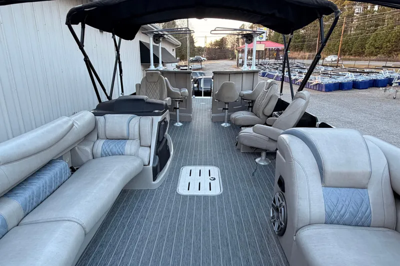 Slide: The Image of 2021 Premier 310 Accolade pontoon boat interior with luxurious seating and canopy. - 11