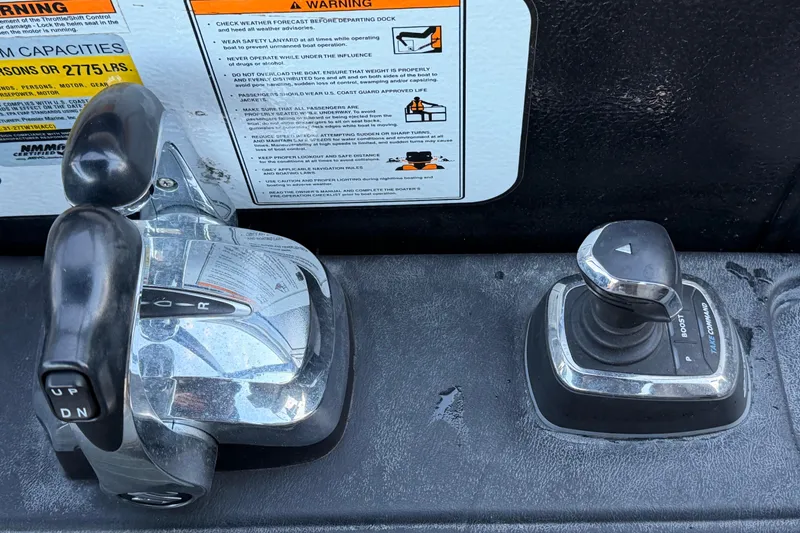 Slide: The Image of Boat control panel of a 2021 Premier 310 Accolade with throttle and joystick. - 17