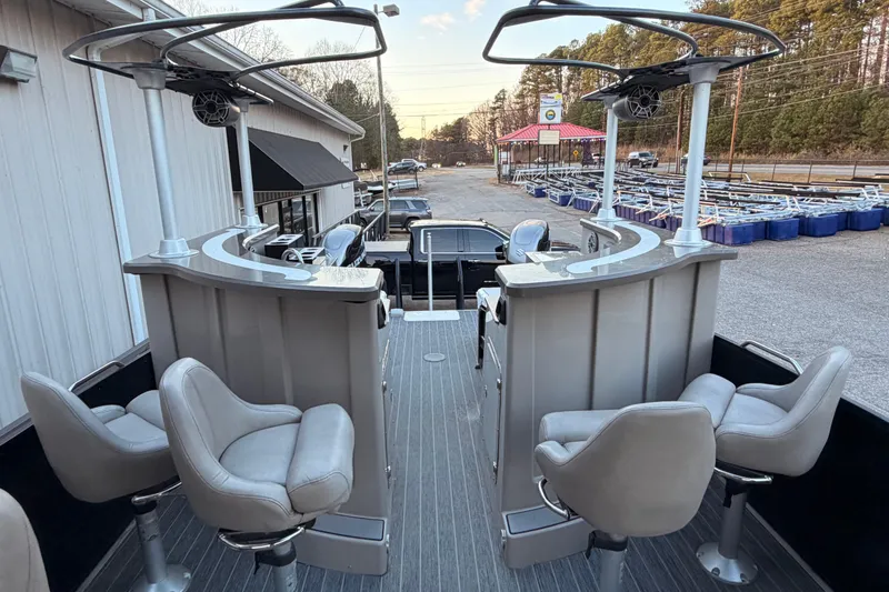 Slide: The Image of 2021 Premier 310 Accolade boat interior with seating and helm, parked outdoors. - 20