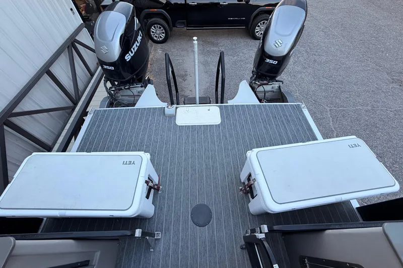 Slide: The Image of 2021 Premier 310 Accolade boat deck with Suzuki engines and Yeti coolers. - 23