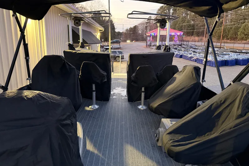 Slide: The Image of 2021 Premier 310 Accolade boat interior with covered seats and outdoor setting. - 24