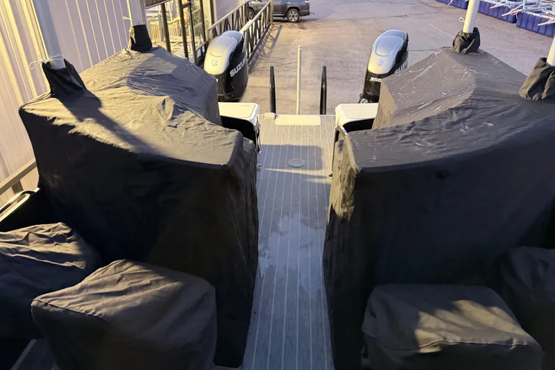 Slide: The Image of 2021 Premier 310 Accolade boat with covered seating and dual Suzuki outboard motors. - 25