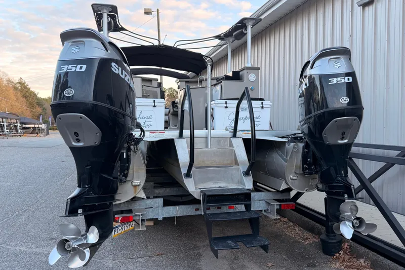 Slide: The Image of 2021 Premier 310 Accolade boat with dual Suzuki 350 engines, docked outdoors. - 3