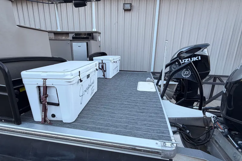 Slide: The Image of Premier 310 Accolade 2021 boat deck with coolers and Suzuki outboard motors. - 4