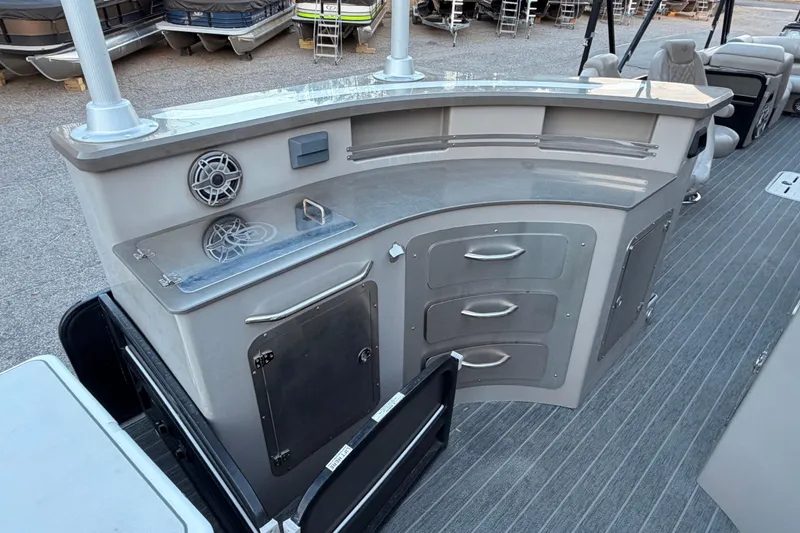 Slide: The Image of 2021 Premier 310 Accolade boat interior with storage cabinets and speaker system. - 8