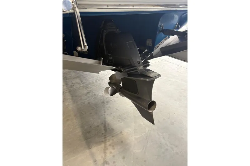 Slide: The Image of 2018 Cobalt R5 Surf boat propeller and stern drive detail in a garage setting. - 10