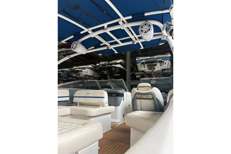 Slide: The Image of 2018 Cobalt R5 Surf boat interior with blue canopy and white seating. - 12