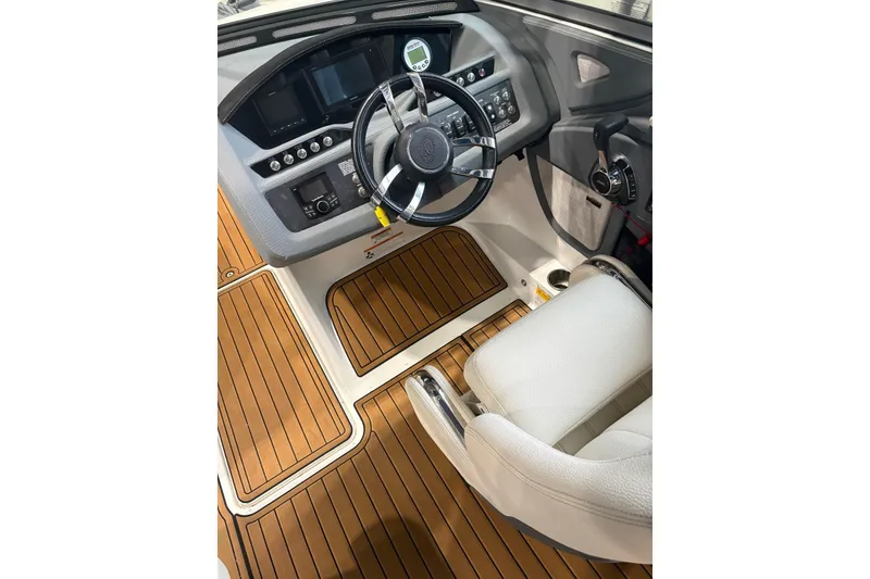 Slide: The Image of 2018 Cobalt R5 Surf boat cockpit with modern controls and wood-style flooring. - 13