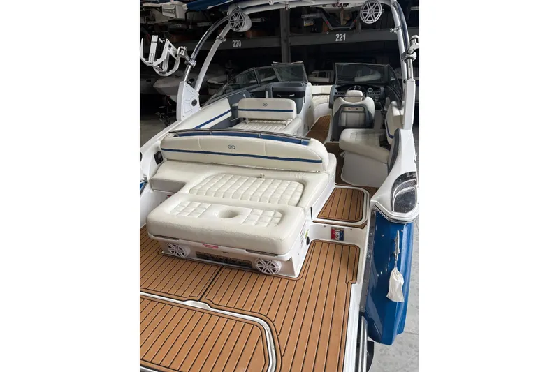 Slide: The Image of 2018 Cobalt R5 Surf boat interior with white seating and wood flooring. - 14