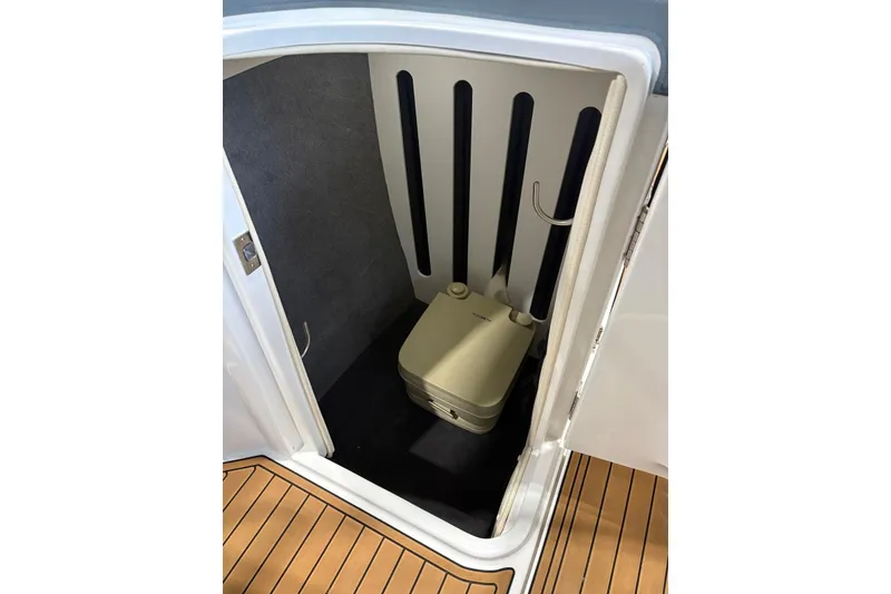 Slide: The Image of 2018 Cobalt R5 Surf boat interior with compact portable toilet. - 19