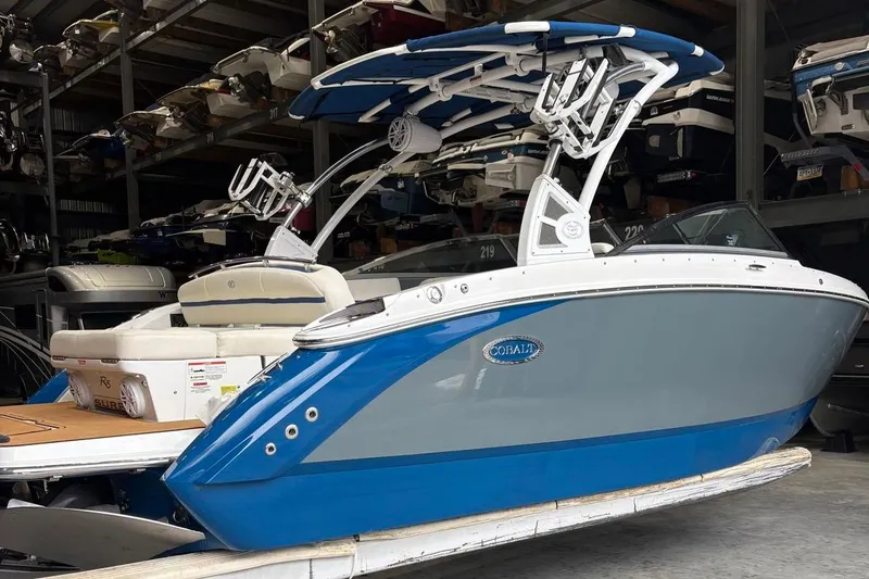 Slide: The Image of 2018 Cobalt R5 Surf boat in storage, featuring sleek blue and gray design. - 3