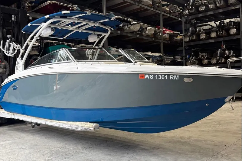 Slide: The Image of 2018 Cobalt R5 Surf boat in storage, featuring a sleek blue and gray design. - 6
