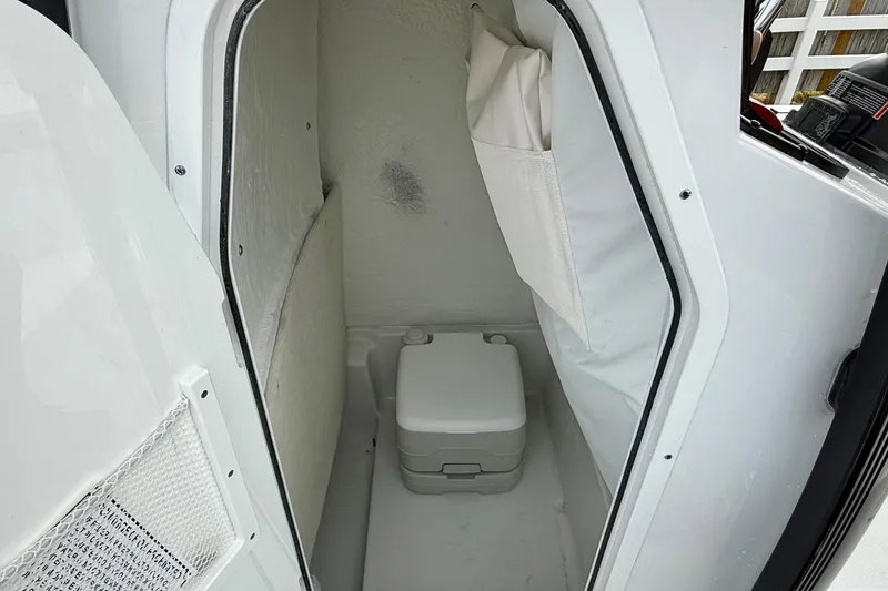 Slide: The Image of Interior of 2026 Sea Hunt BX 22 BR with portable toilet. - 14