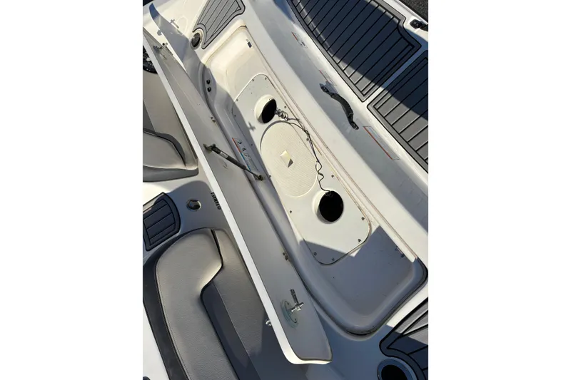 Slide: The Image of 2015 Yamaha Boats 212X interior storage compartment with open hatch and seating. - 22