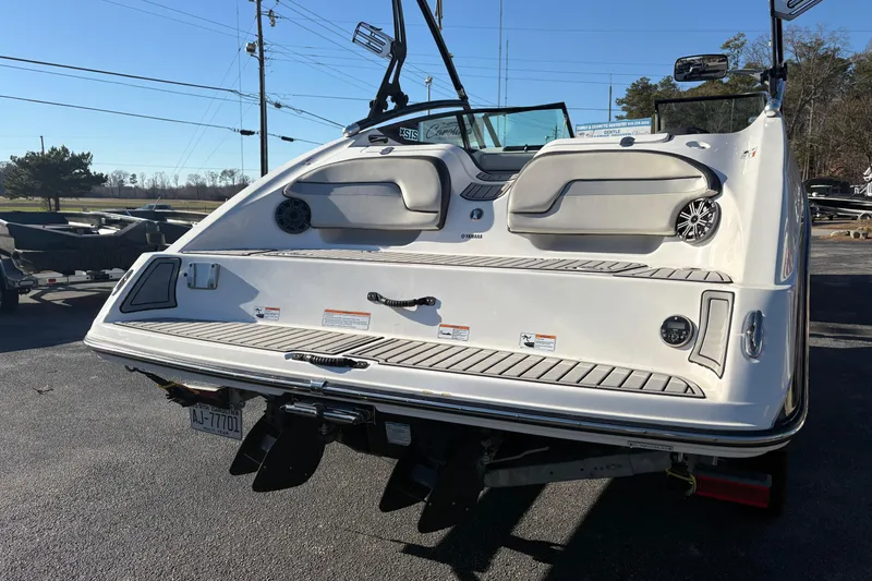Slide: The Image of 2015 Yamaha Boats 212X, rear view, on trailer, outdoor setting. - 5