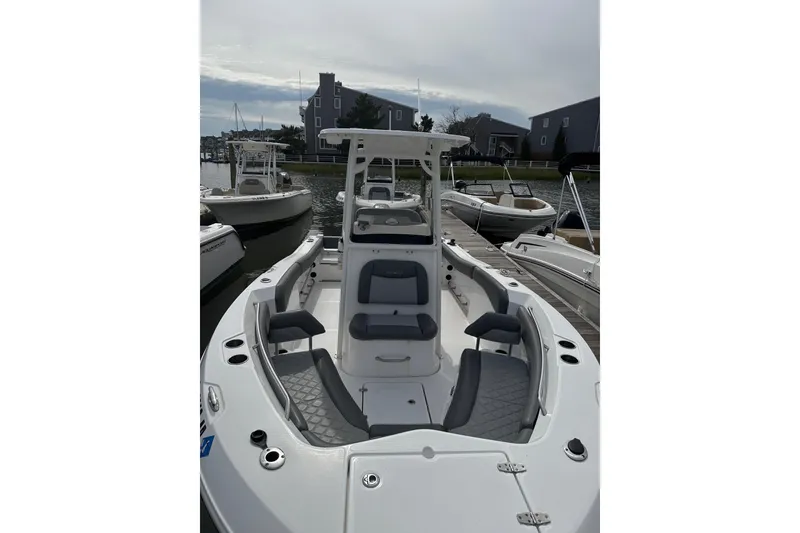 Slide: The Image of 2024 NauticStar 222L Offshore boat docked, showcasing spacious seating and sleek design. - 3