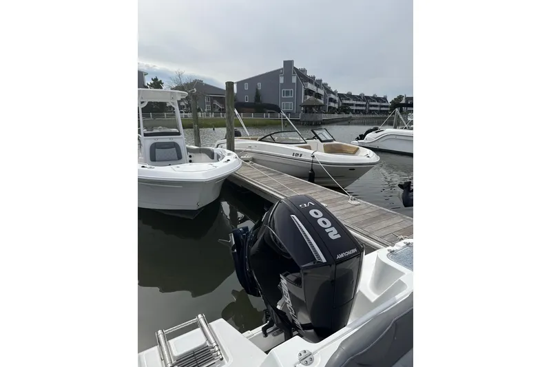 Slide: The Image of 2024 NauticStar 222L Offshore boat docked with Mercury outboard engine. - 7