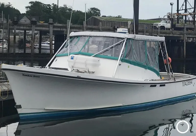 Slide: The Image of 1988 JC Provincetown boat docked at marina with green canopy. - 1