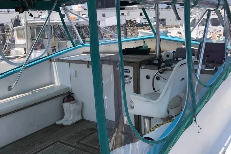 Slide: The Image of Interior of a 1988 JC Provincetown boat with white captain's chair and dashboard. - 10