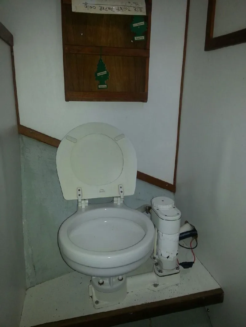 Slide: The Image of 1988 JC Provincetown boat toilet with wooden cabinet and air fresheners. - 15