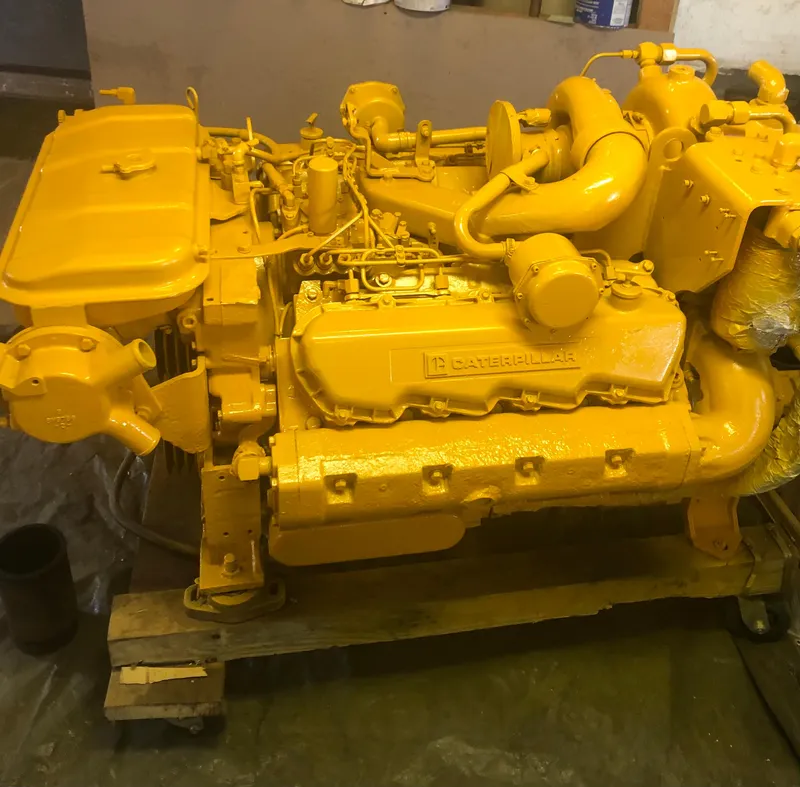Slide: The Image of Yellow Caterpillar engine from a 1988 JC Provincetown boat, displayed on a wooden pallet. - 16