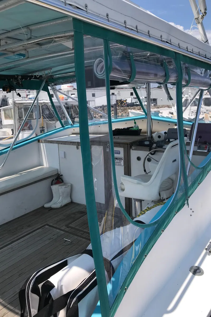 Slide: The Image of 1988 JC Provincetown boat interior with teal trim and white seating. - 11