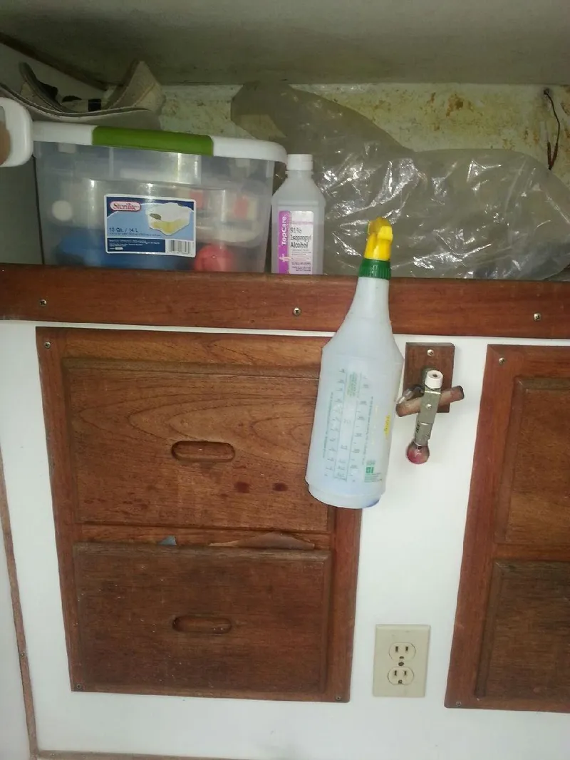 Slide: The Image of Wooden cabinet with cleaning supplies in a 1988 JC Provincetown boat. - 13
