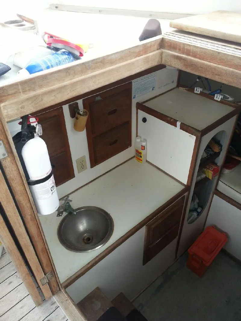 Slide: The Image of 1988 JC Provincetown boat interior with sink and storage cabinets. - 14