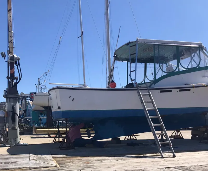 Slide: The Image of 1988 JC Provincetown boat undergoing maintenance at a dockyard. - 3