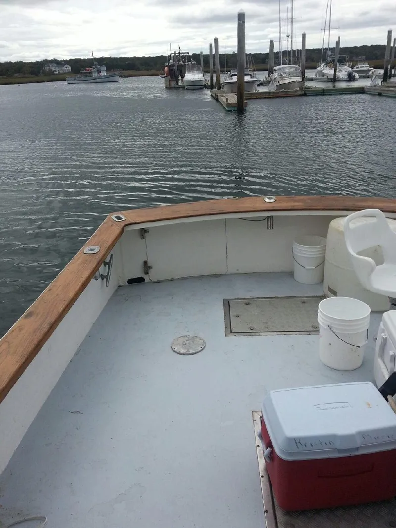 Slide: The Image of 1988 JC Provincetown boat docked at a marina with calm waters. - 5