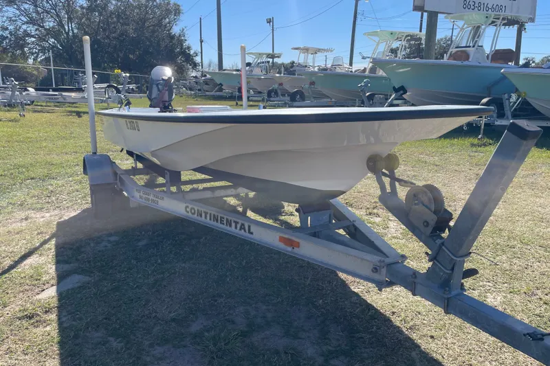 Slide: The Image of 1985 Boston Whaler 15' boat on Continental trailer in a sunny outdoor setting. - 12