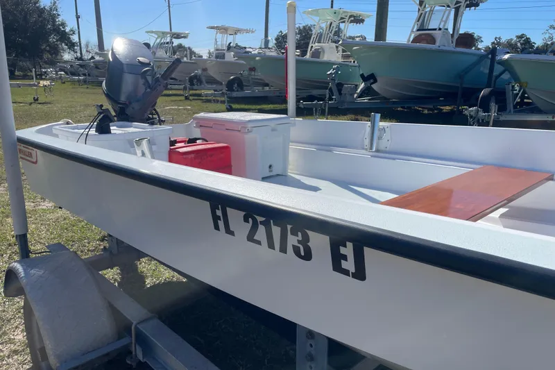 Slide: The Image of 1985 Boston Whaler 15' boat on trailer, with outboard motor and registration FL 2173 EJ. - 2