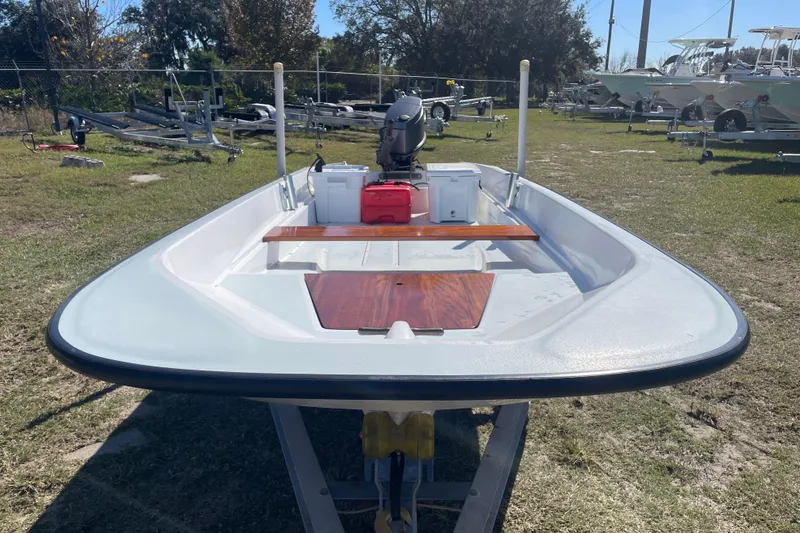 Slide: The Image of 1985 Boston Whaler 15' boat on trailer, outdoor setting, clear sky. - 4