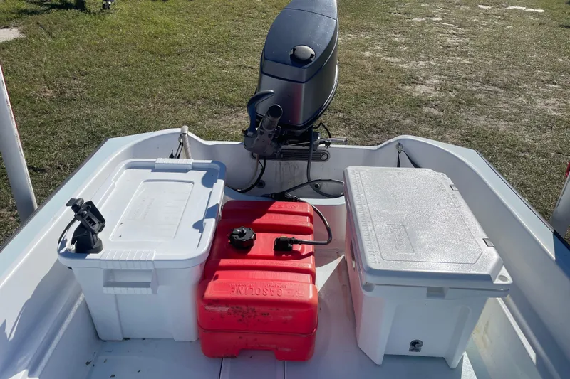Slide: The Image of 1985 Boston Whaler 15' boat with outboard motor, fuel tank, and storage containers. - 8