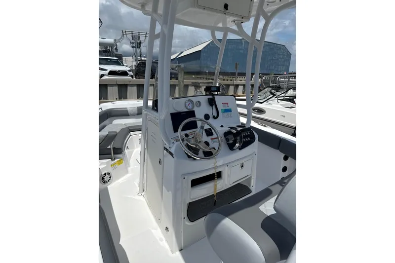Slide: The Image of 2024 NauticStar 222L Offshore boat console with steering wheel and controls. - 5