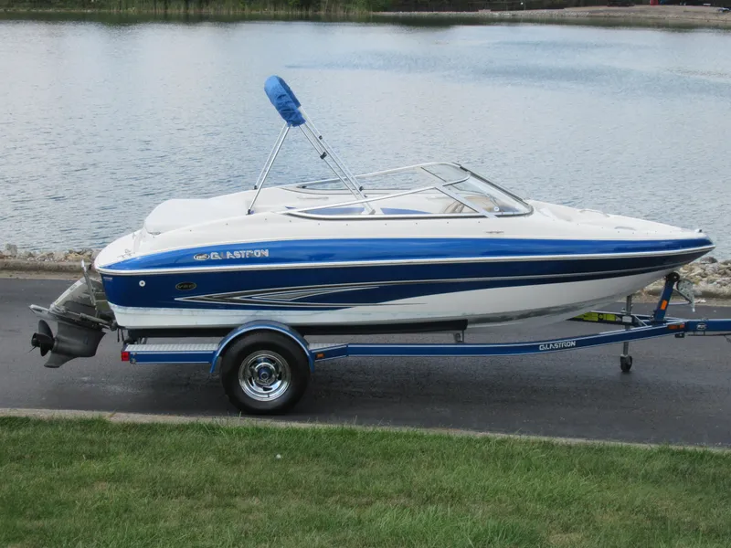 The Image of 2008 Glastron GXL 185 boat on trailer by a lake. - 0
