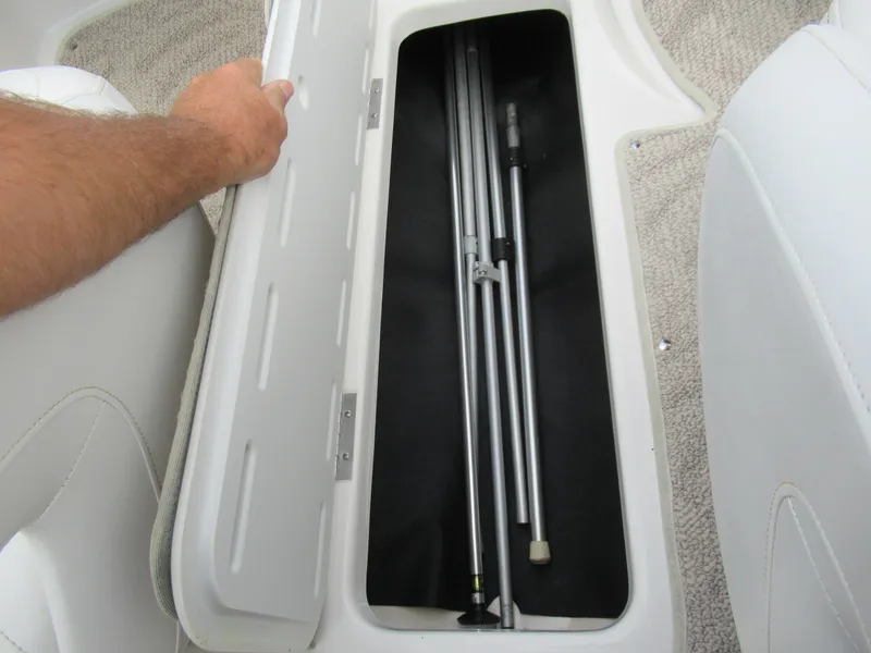 Slide: The Image of Storage compartment in a 2008 Glastron GXL 185 boat with metal poles inside. - 12