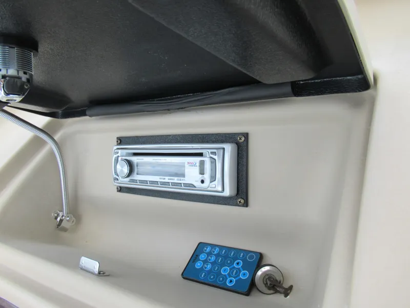 Slide: The Image of 2008 Glastron GXL 185 boat dashboard with stereo system and remote control. - 14