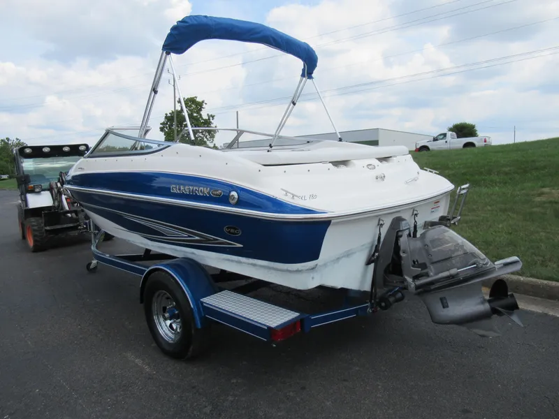 Slide: The Image of 2008 Glastron GXL 185 boat with blue and white exterior on a trailer. - 3