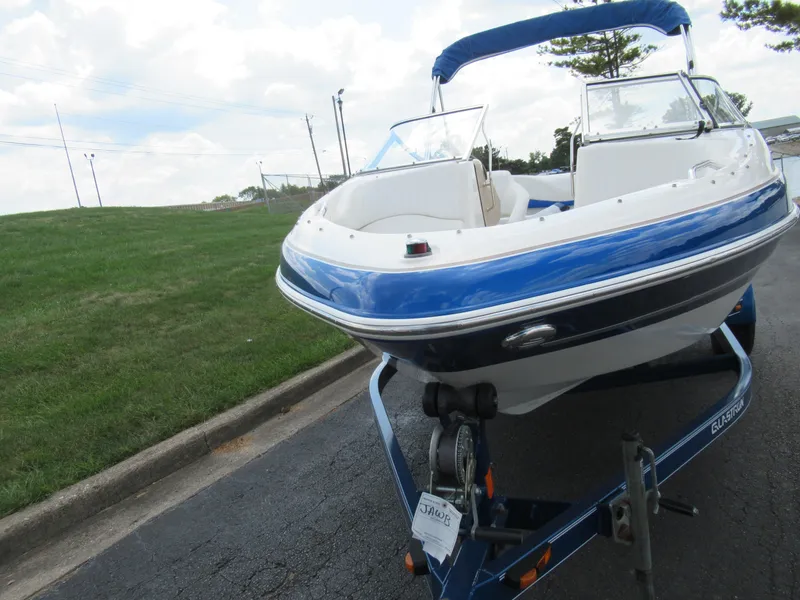 Slide: The Image of 2008 Glastron GXL 185 boat on a trailer, blue and white exterior. - 6