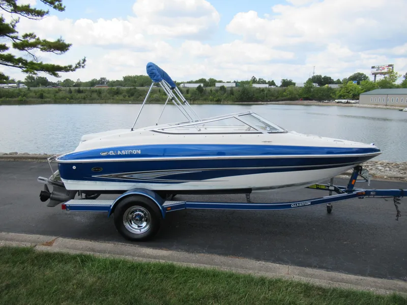 Slide: The Image of 2008 Glastron GXL 185 boat on trailer by a lake. - 9