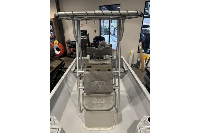 Slide: The Image of 2026 G3 Bay 22 GX boat interior with seating and T-top in showroom. - 7