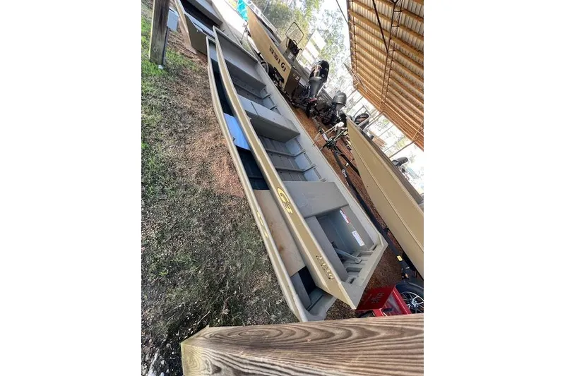 The Image of 2026 G3 Gator Tough 1436 LW boat displayed outdoors under a wooden shelter. - 1