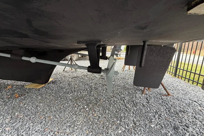 Slide: The Image of Underside view of 1984 Golden Star 38 Trawler showing propeller and rudder on gravel. - 10