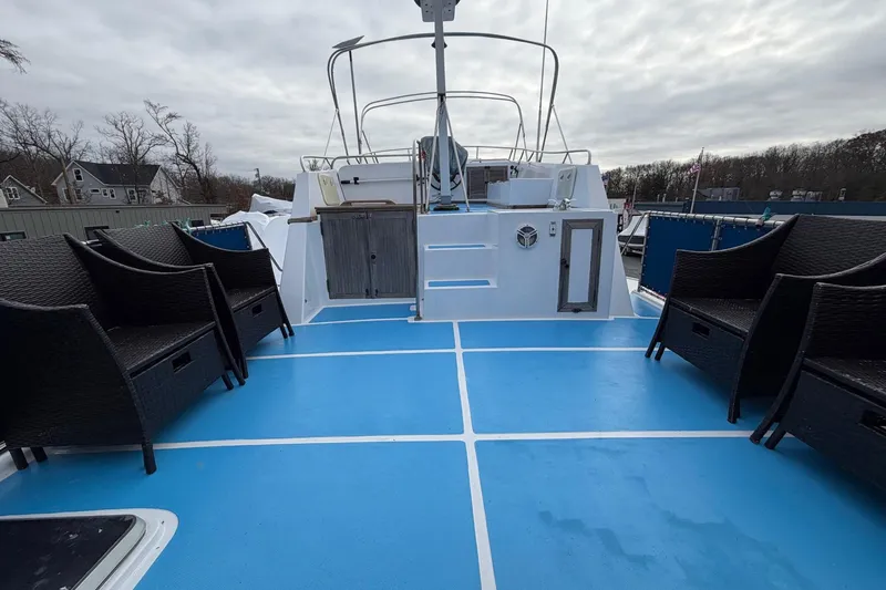Slide: The Image of 1984 Golden Star 38 Trawler deck with wicker chairs and blue flooring. - 14
