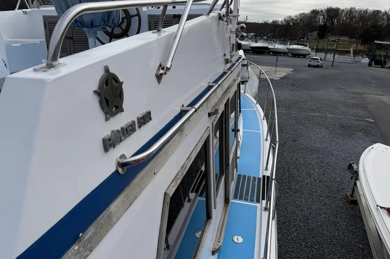 Slide: The Image of 1984 Golden Star 38 Trawler docked, showcasing sleek design and blue deck accents. - 20