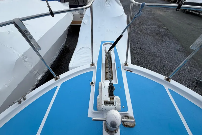 Slide: The Image of Bow view of 1984 Golden Star 38 Trawler, featuring blue deck and anchor mechanism. - 22