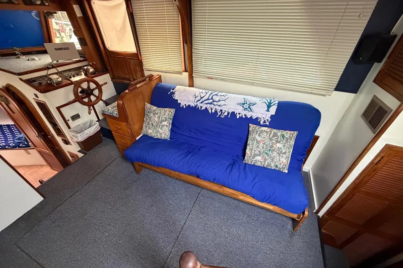 Slide: The Image of Interior of 1984 Golden Star 38 Trawler with blue sofa and nautical decor. - 28